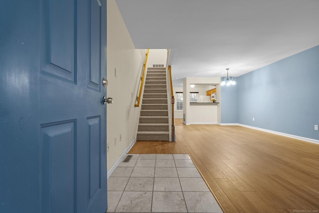 entryway featuring a chandelier and light wood-type flooring