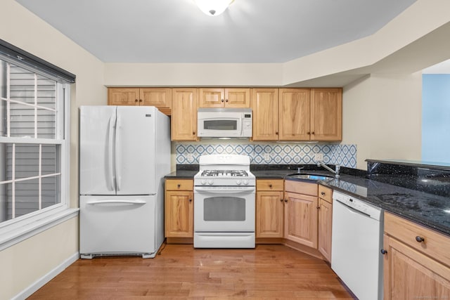 kitchen featuring tasteful backsplash, sink, white appliances, and light hardwood / wood-style floors