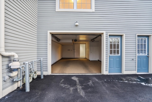 doorway to property with a garage