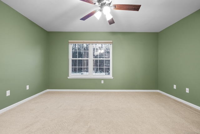 spare room featuring ceiling fan and carpet floors