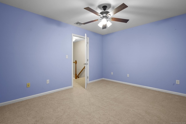 spare room with light carpet and ceiling fan