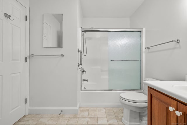 full bathroom with vanity, combined bath / shower with glass door, tile patterned floors, and toilet