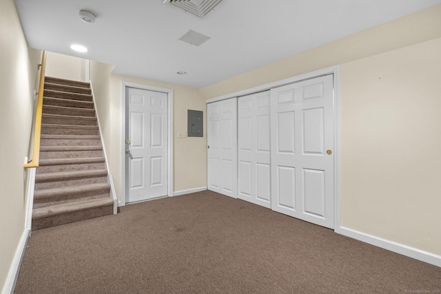 unfurnished bedroom featuring carpet, electric panel, and a closet