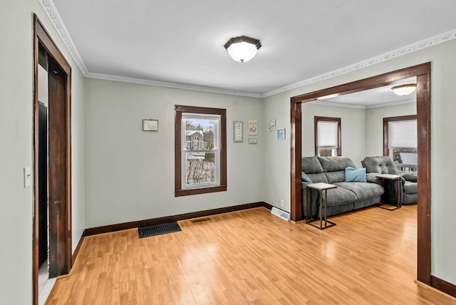 entryway with wood-type flooring and ornamental molding