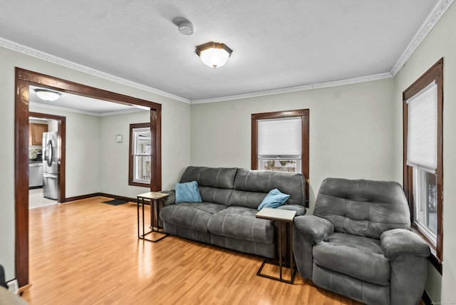 living room featuring crown molding and light wood-type flooring