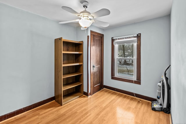 unfurnished bedroom with ceiling fan and light wood-type flooring