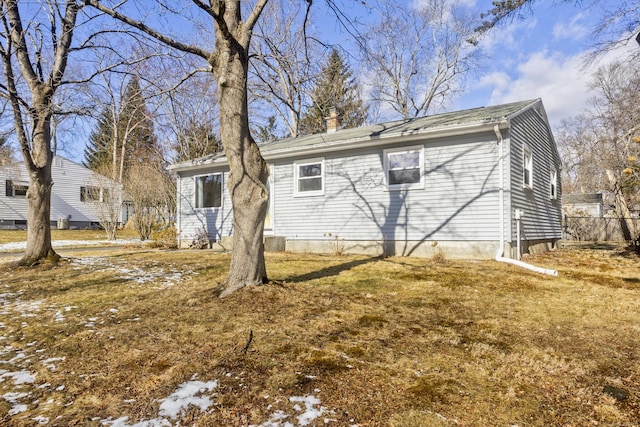 rear view of property featuring a yard