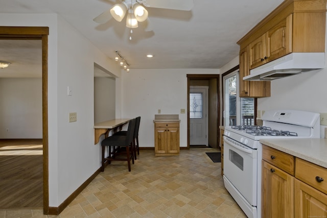 kitchen featuring white range with gas stovetop and ceiling fan