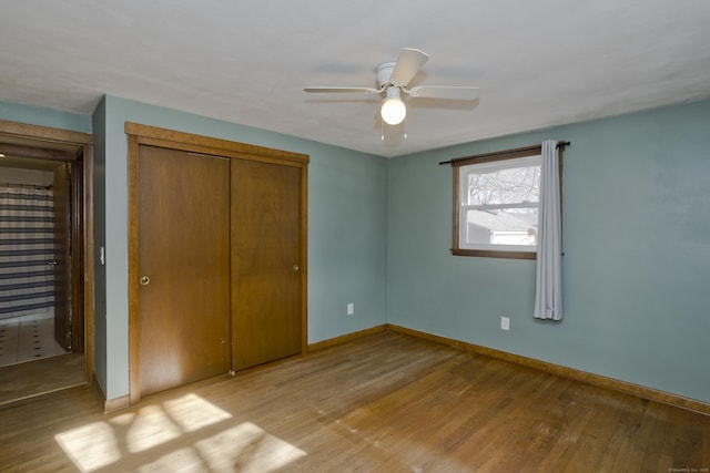 unfurnished bedroom with light hardwood / wood-style floors, a closet, and ceiling fan