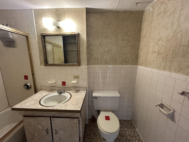 bathroom with vanity, tile walls, and toilet