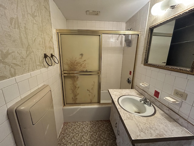 full bathroom with radiator, combined bath / shower with glass door, tile walls, vanity, and toilet