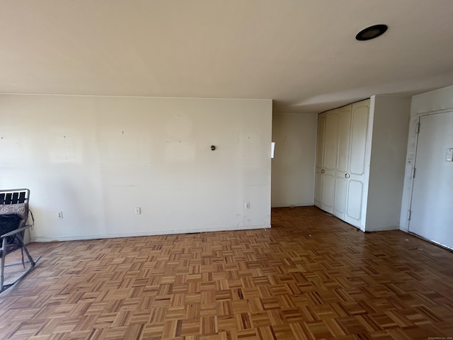 unfurnished room with light parquet flooring