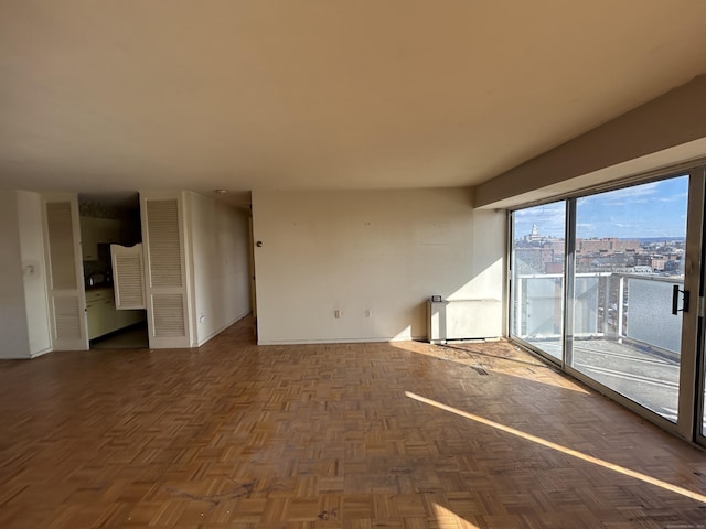 unfurnished living room with dark parquet floors