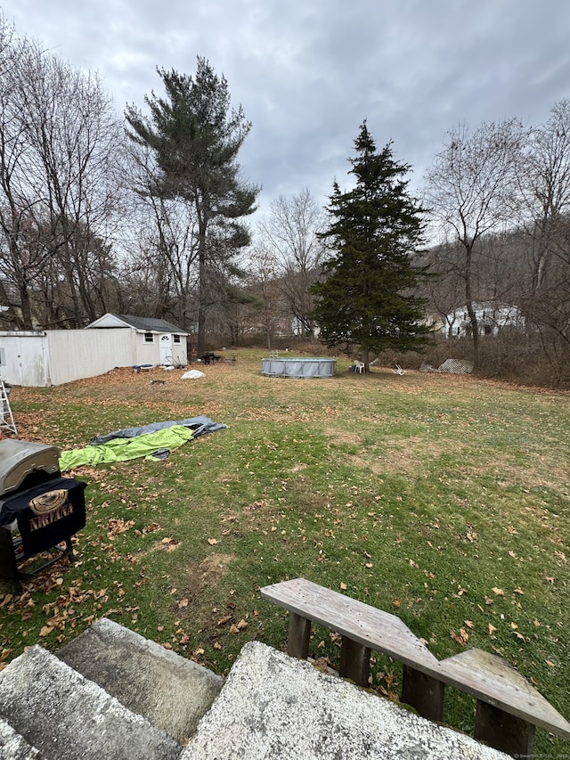 view of yard featuring a covered pool