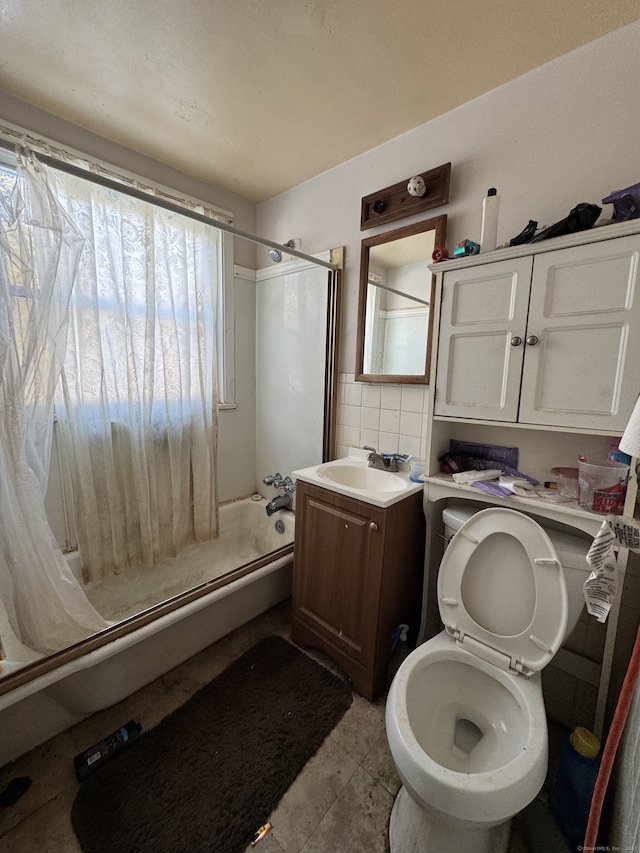 bathroom with vanity, decorative backsplash, and toilet