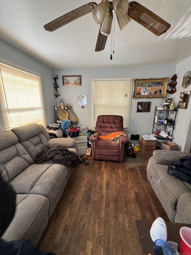 living room with dark hardwood / wood-style floors and ceiling fan