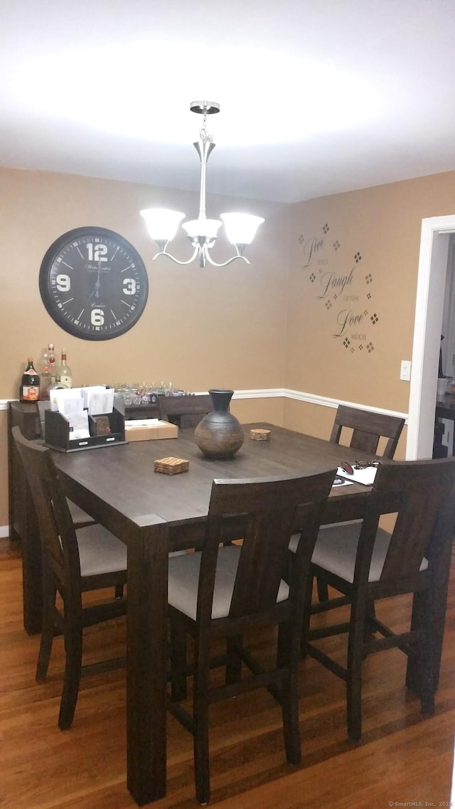 dining room featuring a notable chandelier and hardwood / wood-style flooring