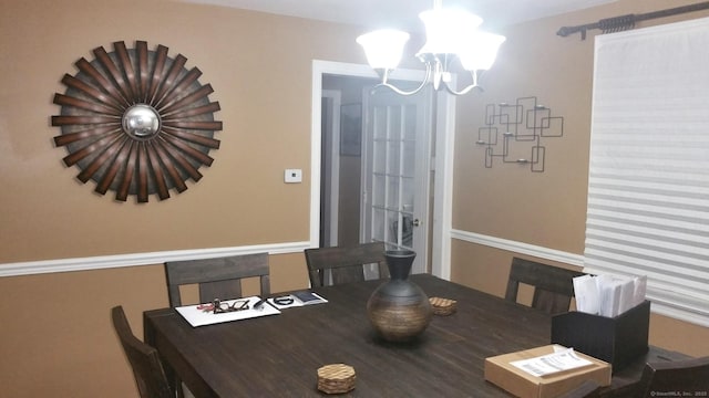 dining space featuring a chandelier