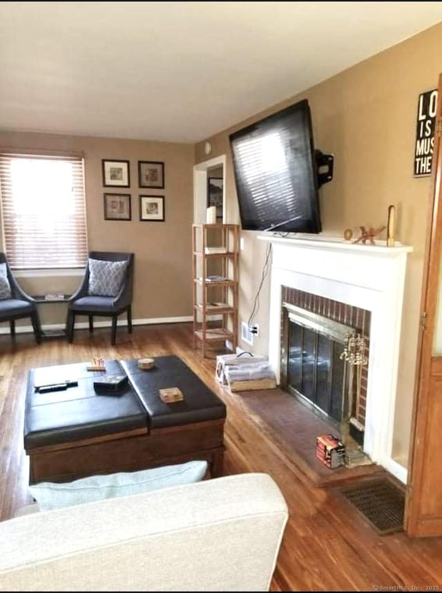 living room with hardwood / wood-style flooring and a fireplace