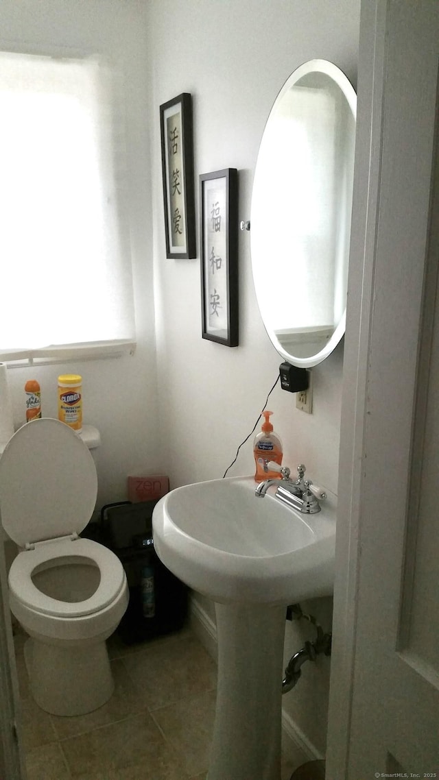 bathroom with tile patterned floors, toilet, and sink