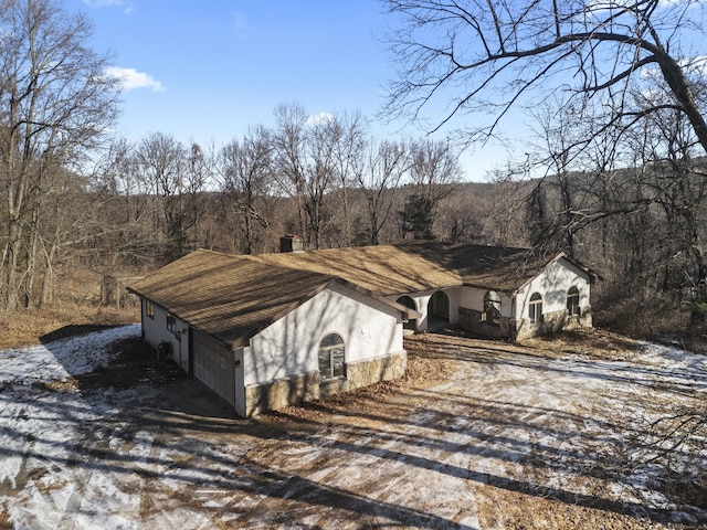 view of side of home featuring a garage