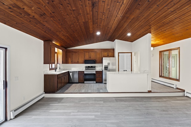 kitchen featuring a baseboard radiator, appliances with stainless steel finishes, sink, and lofted ceiling