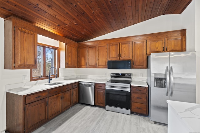 kitchen with lofted ceiling, sink, wood ceiling, appliances with stainless steel finishes, and light stone counters