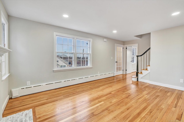 interior space with a baseboard heating unit and light wood-type flooring