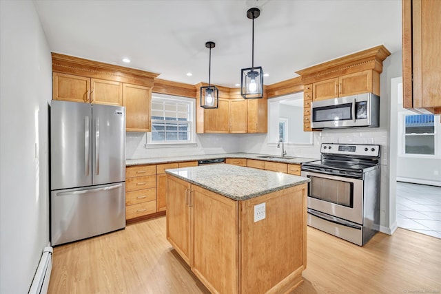 kitchen featuring a kitchen island, a baseboard radiator, sink, hanging light fixtures, and stainless steel appliances