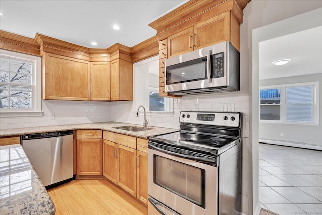 kitchen featuring sink, decorative backsplash, plenty of natural light, and stainless steel appliances