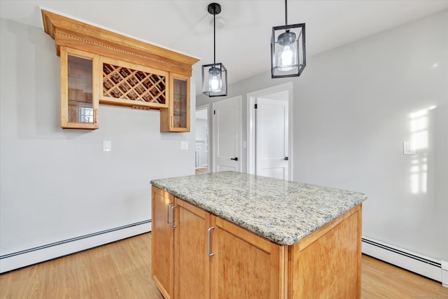 kitchen with light wood-type flooring, hanging light fixtures, and a baseboard heating unit