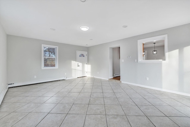 tiled spare room featuring a baseboard radiator