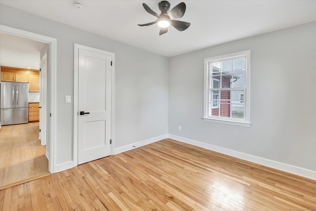 unfurnished room featuring ceiling fan and light hardwood / wood-style flooring