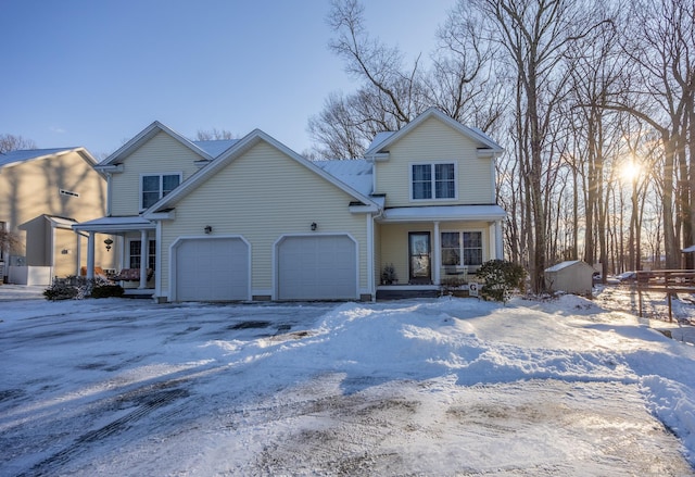 view of property with a garage and a porch