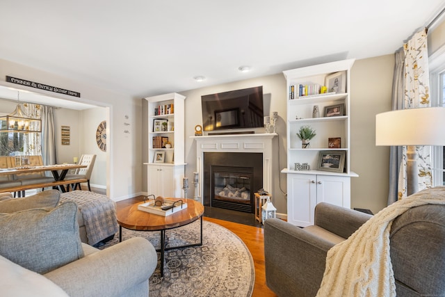 living room featuring an inviting chandelier and wood-type flooring