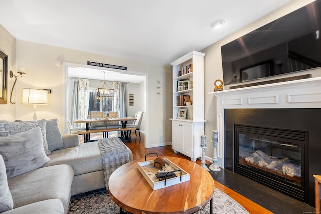 living room with hardwood / wood-style floors and a notable chandelier