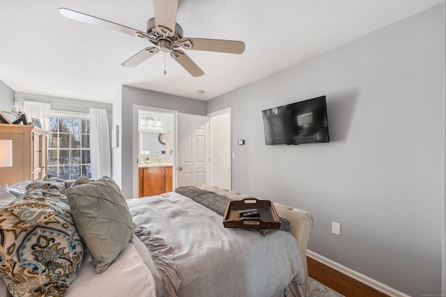 bedroom featuring sink, hardwood / wood-style floors, ceiling fan, and ensuite bathroom