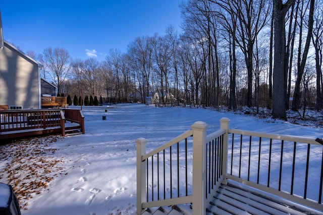 snowy yard featuring a deck