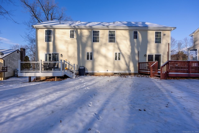 snow covered property featuring a deck