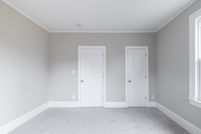 unfurnished bedroom featuring crown molding and carpet floors