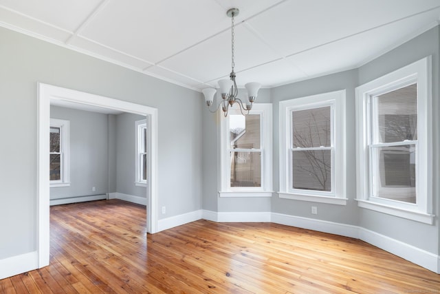 unfurnished dining area featuring a baseboard radiator, wood-type flooring, and an inviting chandelier