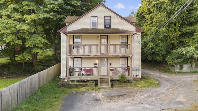 view of front of property with a porch and a balcony