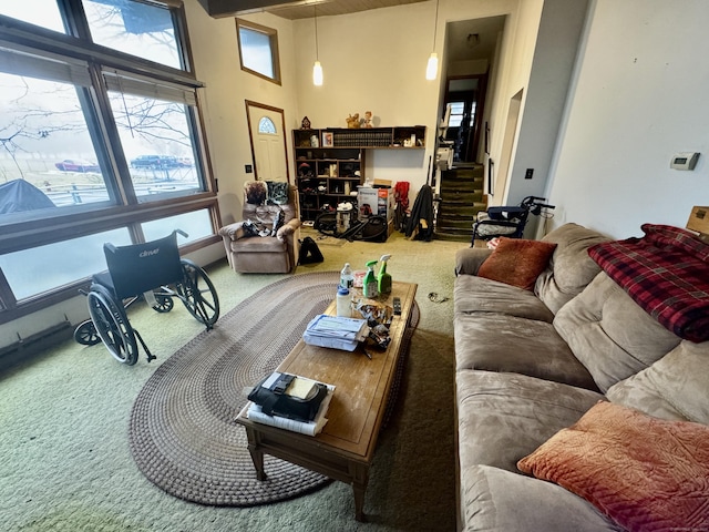 living room featuring a towering ceiling and carpet