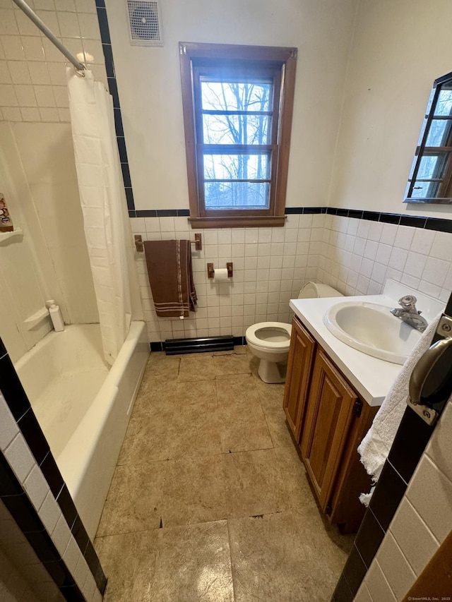 full bathroom featuring shower / bath combination with curtain, vanity, toilet, and tile walls