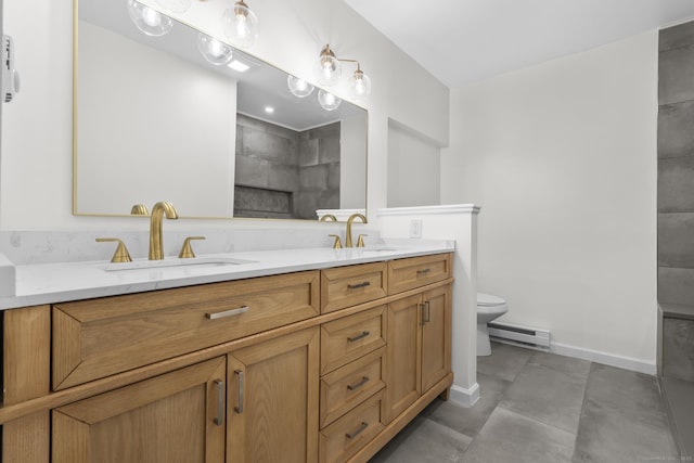 bathroom featuring a baseboard radiator, vanity, and toilet