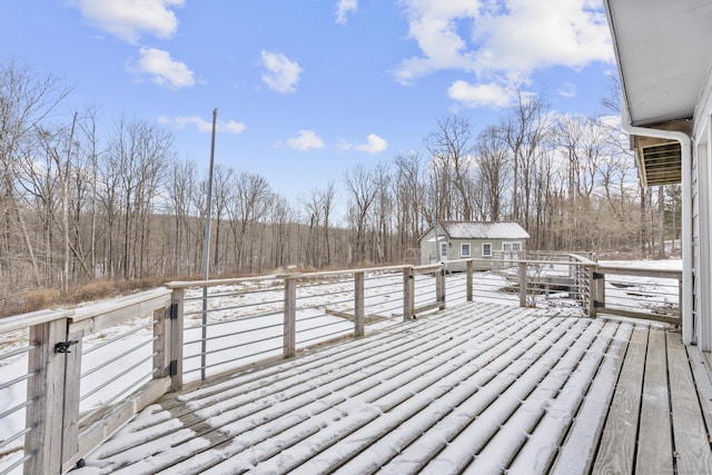 snow covered deck with an outbuilding