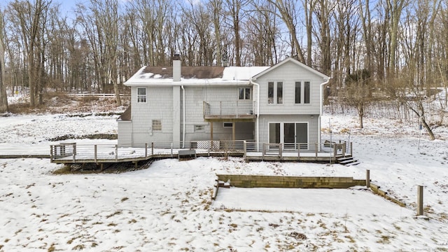 snow covered property featuring a wooden deck