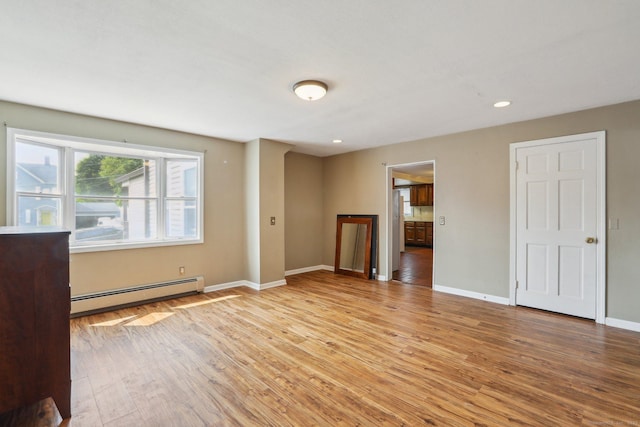 15 Seeley St, Danbury, CT 06810 - unfurnished living room with a baseboard heating unit, light wood finished floors, baseboards, and recessed lighting