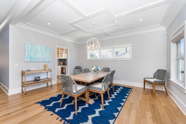 dining room with coffered ceiling, light hardwood / wood-style flooring, and ornamental molding