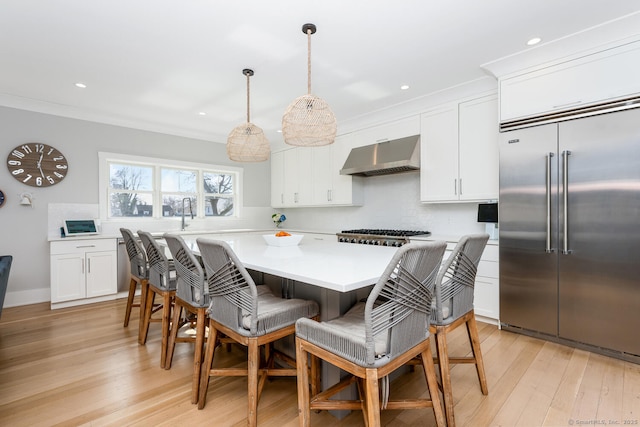 dining area featuring crown molding and light wood-type flooring